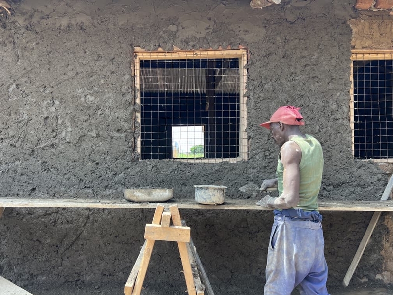  A community member renovating a classroom bloc